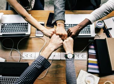 Hands all bumping together as a team